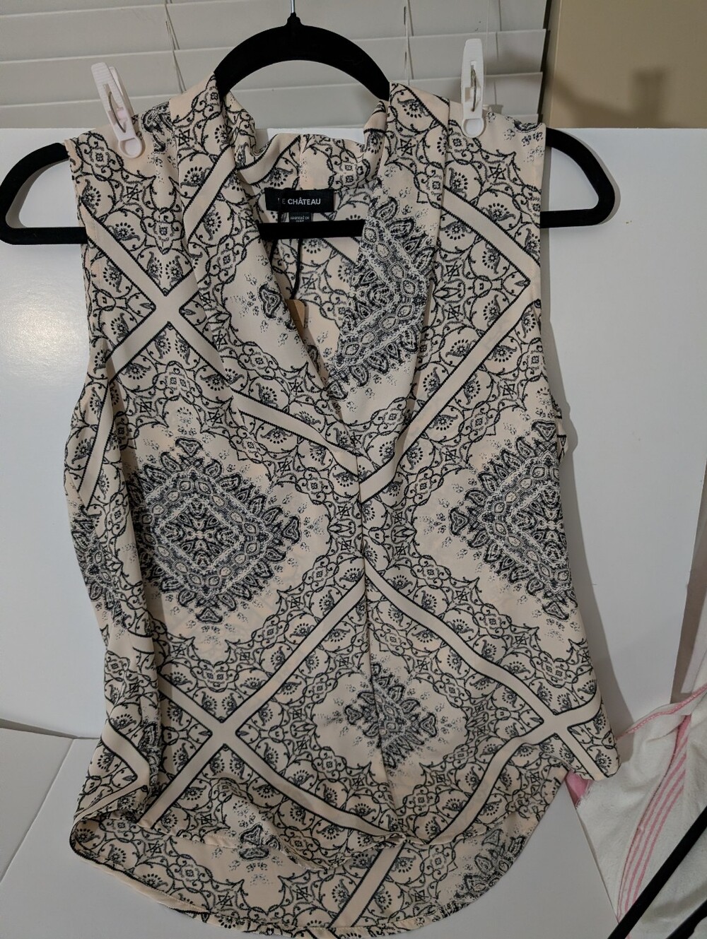 Le Chateau Cream Sleeveless Printed Blouse with Black Geometric Motif.